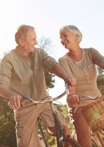 Retired Couple Riding Bikes - Retirement Planning Services